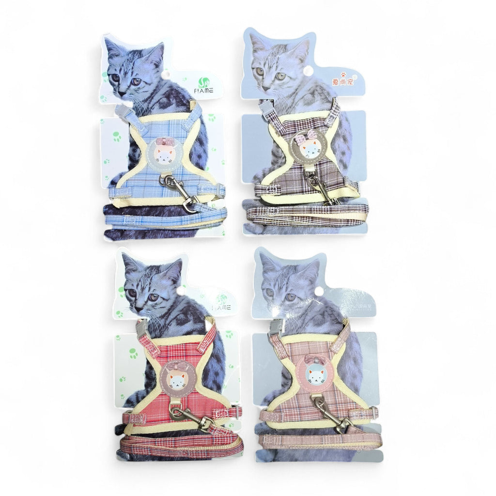 Four plaid cat harnesses with matching leashes in blue, brown, red, and pink. Each harness features a cute cat face emblem and adjustable straps.