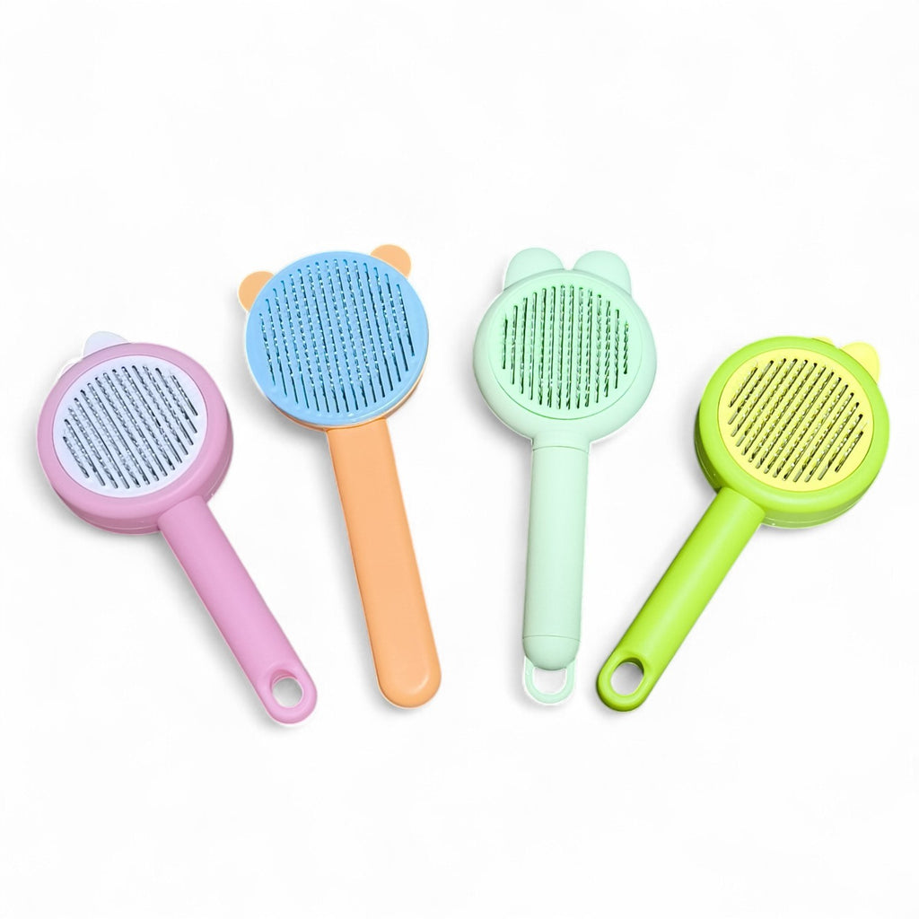 Maroc-animalerie self-cleaning pet grooming brush in pink, orange, mint green, and lime green. Features gentle bristles and a retractable design.