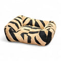 Maroc-animalerie plush pet bed with black and tan zebra print. Cozy, durable, and comfortable for small to medium pets.
